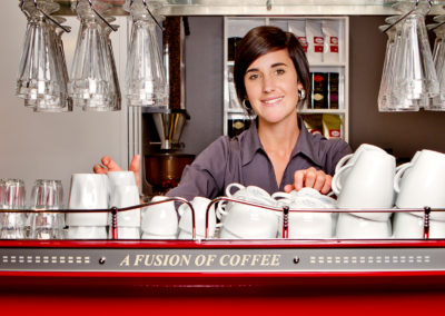 lady barista behind coffee machine