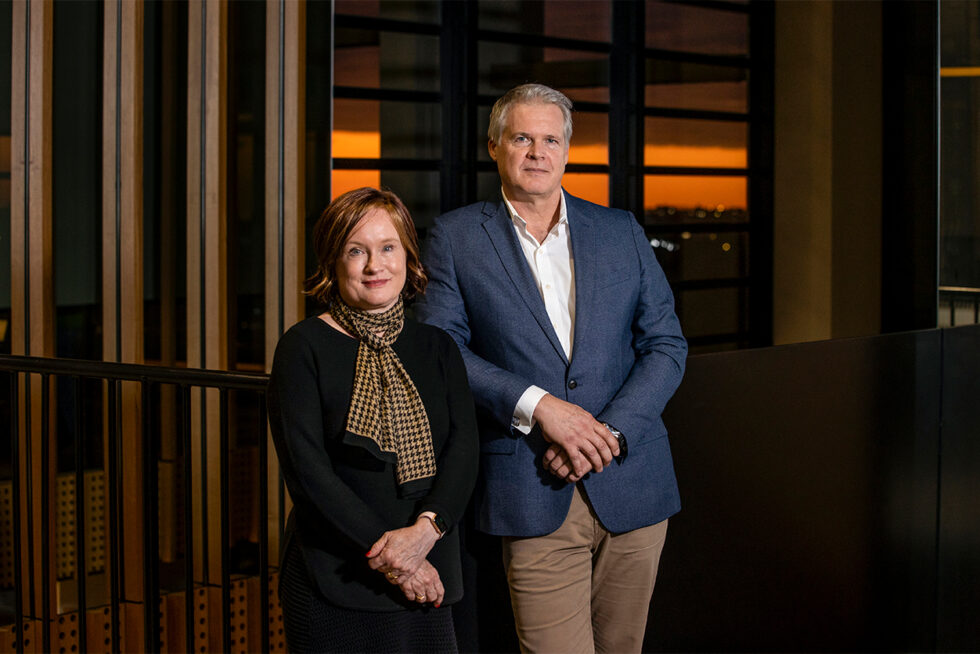 Professional portrait of two executives photographed on location using studio lighting inside a contemporary corporate office in Adelaide, South Australia.