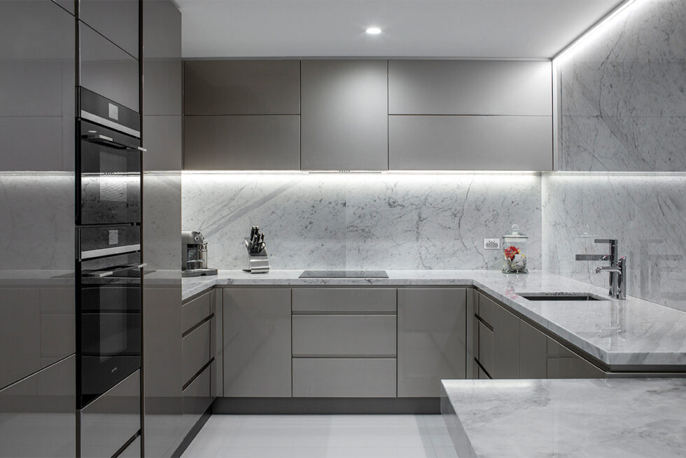 Contemporary designer kitchen featuring marble benchtops, custom cabinetry, and architectural lighting in a luxury Adelaide home.