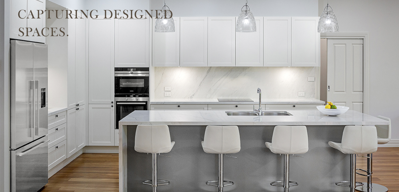 Luxury contemporary kitchen photographed by Australian interior and architectural photographer John Nieddu, showcasing premium cabinetry, stone benchtops and modern residential design.