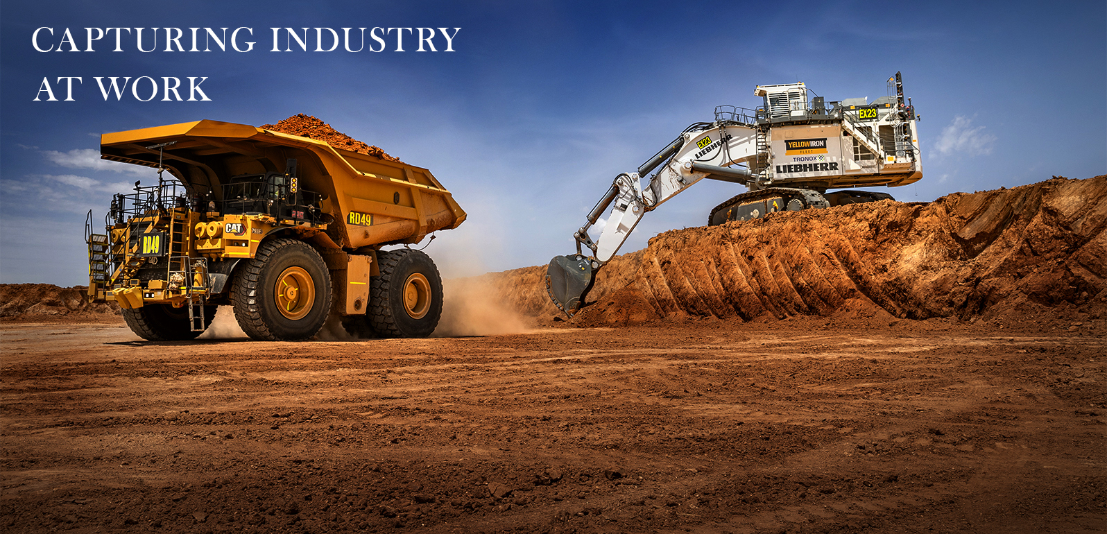Large mining excavator loading a Caterpillar haul truck during open-cut mining operations. Commercial mining photography by John Nieddu Photography Adelaide.